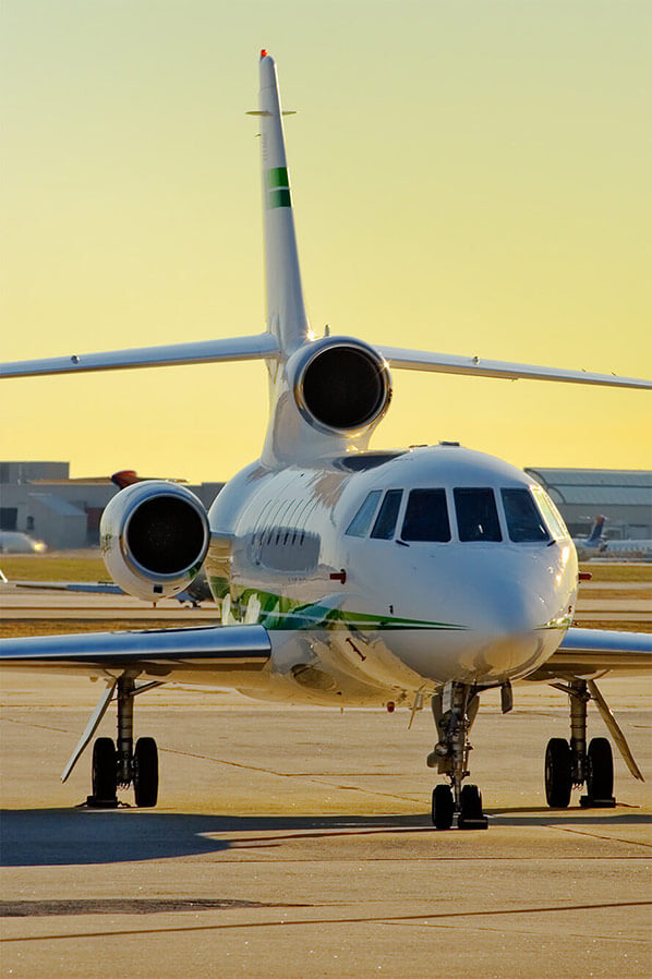 Business jet on the ramp at sunset